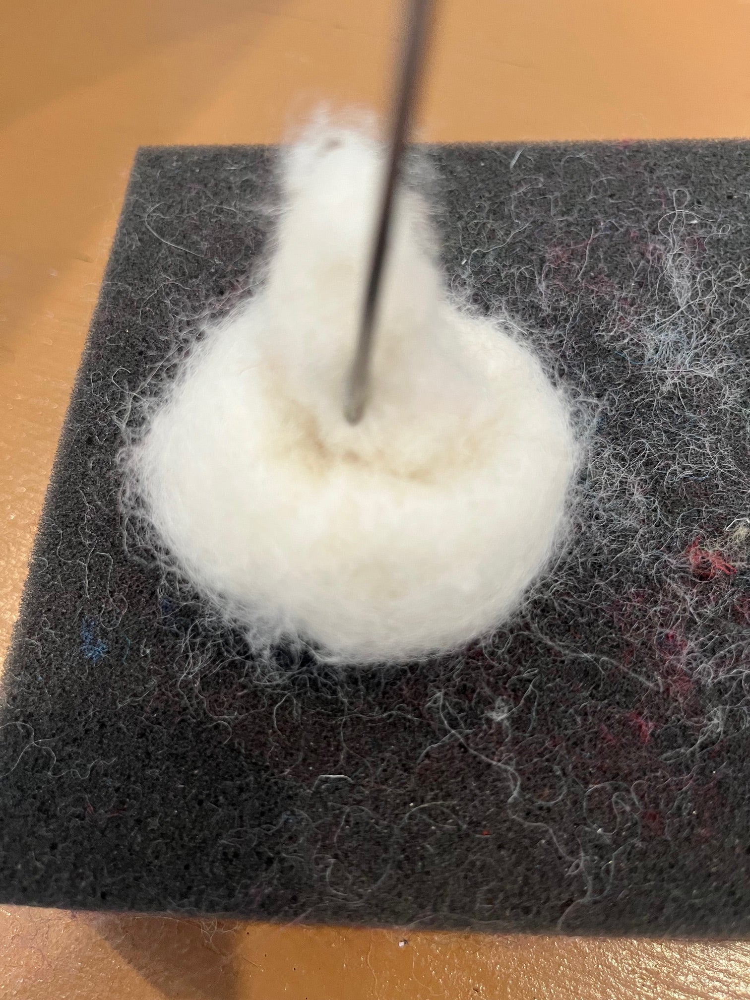IKneedle felted ivory wool roving into the soon to be shape of a mushroom by Caron Designs