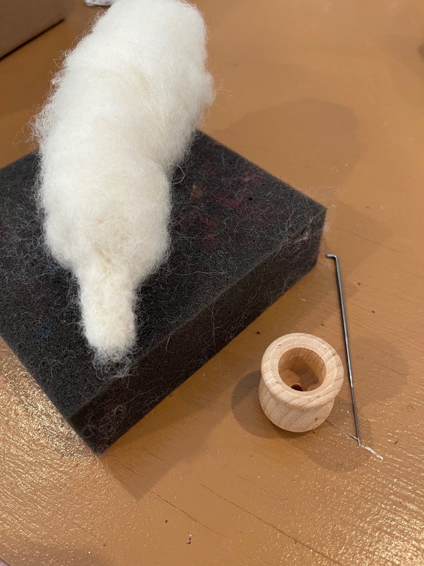 Ivory wool roving the start of a needle felting project that will eventually be a felted mushroom, Kit offered by Caron Designs
